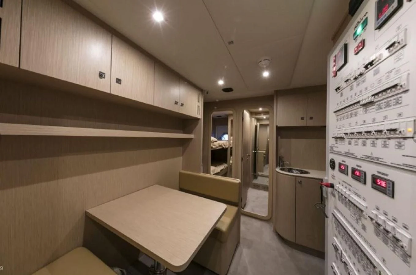 a kitchen with a table and refrigerator aboard OXIDANTE Yacht for Sale