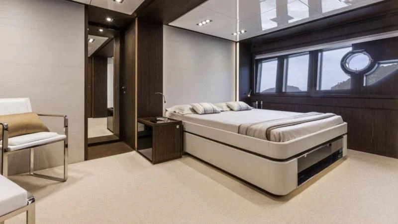 a room with a bed and a chair aboard OXIDANTE Yacht for Sale