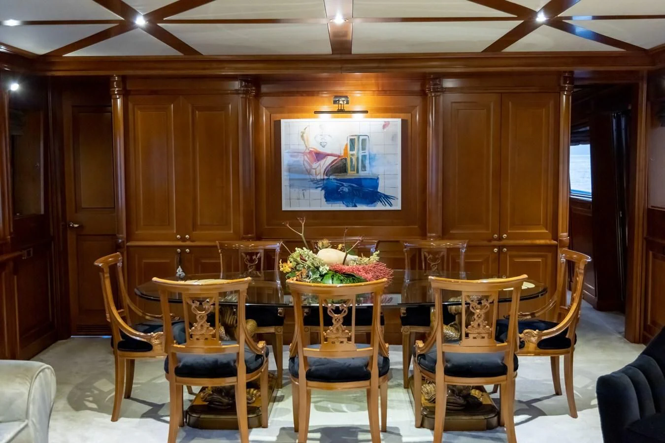 a room with chairs and a table aboard AQUILLA Yacht for Sale