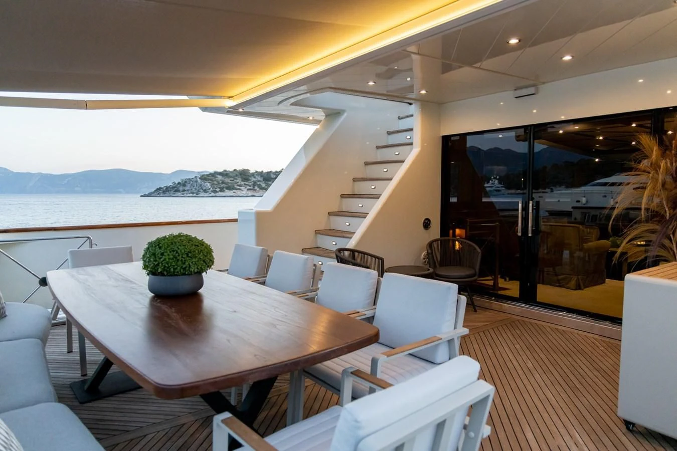 a room with a table chairs and a large window aboard AQUILLA Yacht for Sale