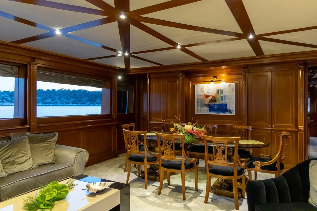 a living room with a table and chairs aboard AQUILLA Yacht for Sale