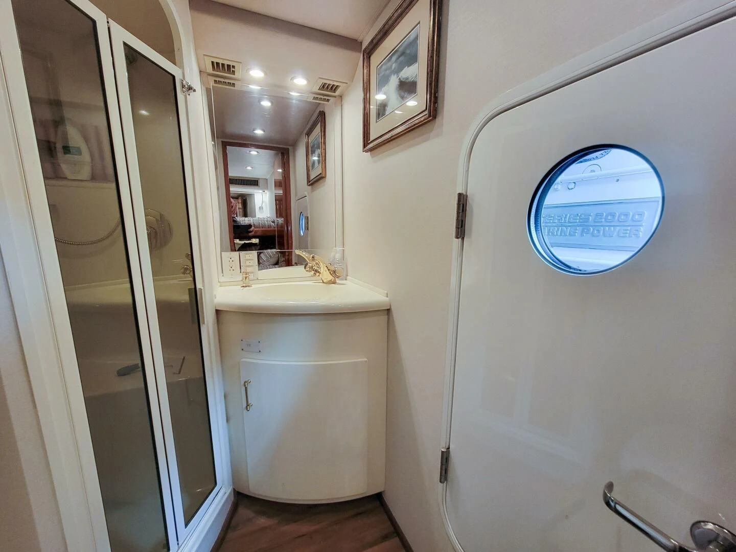 a bathroom with a large mirror aboard PRIME TIME Yacht for Sale