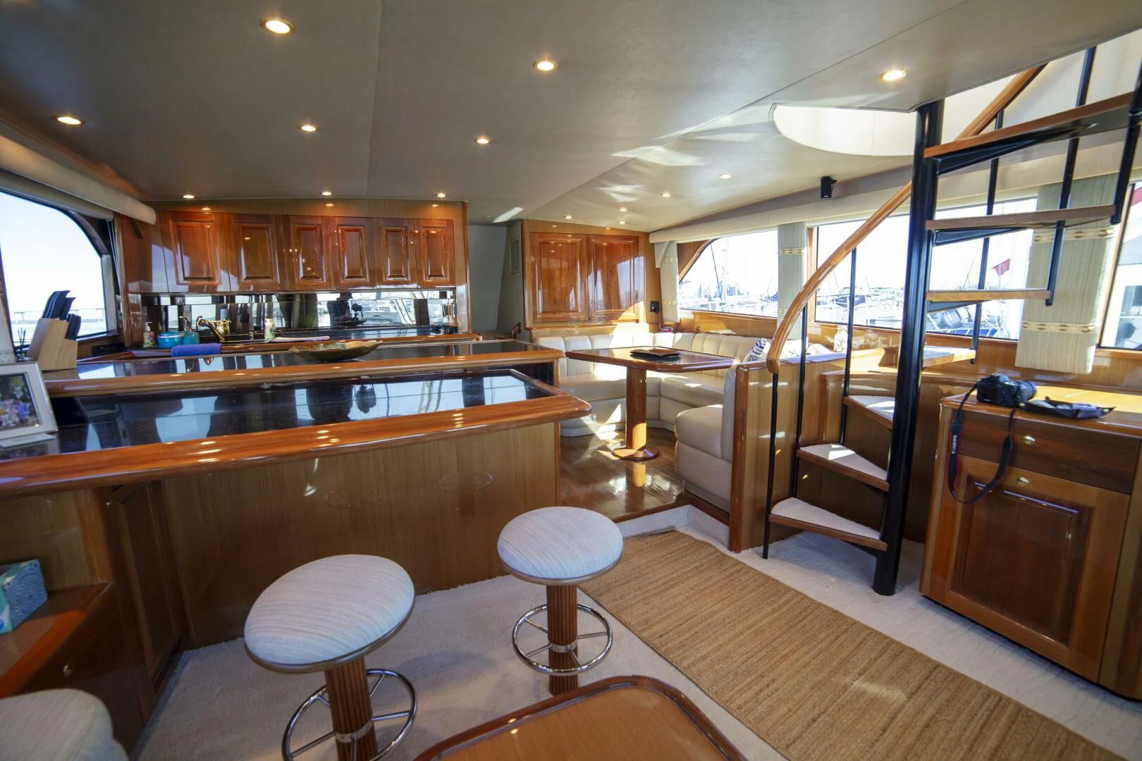 a large room with wooden cabinets aboard PRIME TIME Yacht for Sale
