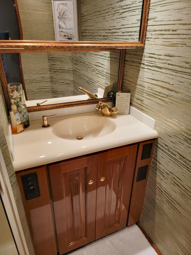 a bathroom with a sink and a mirror aboard PRIME TIME Yacht for Sale