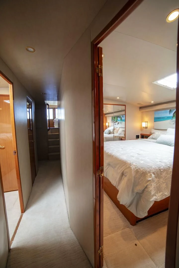 a room with a bed and a hallway aboard PRIME TIME Yacht for Sale