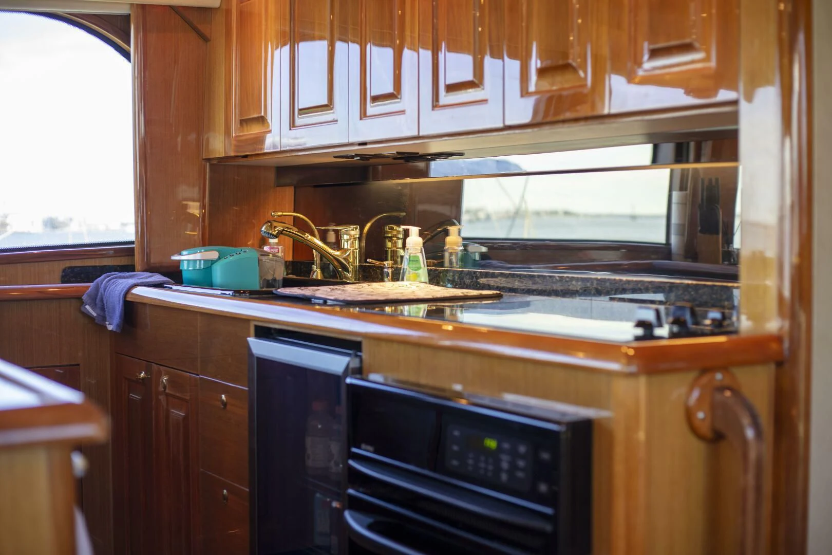 a kitchen with a stove and cabinets aboard PRIME TIME Yacht for Sale