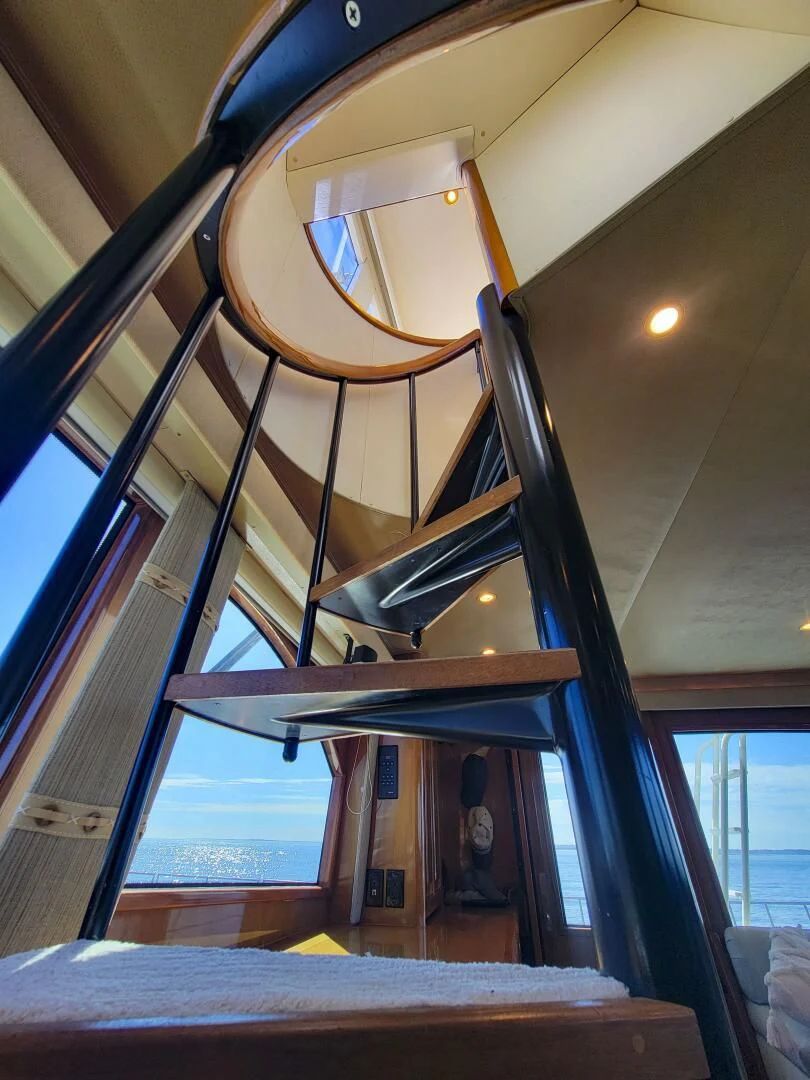 a staircase with a glass window aboard PRIME TIME Yacht for Sale