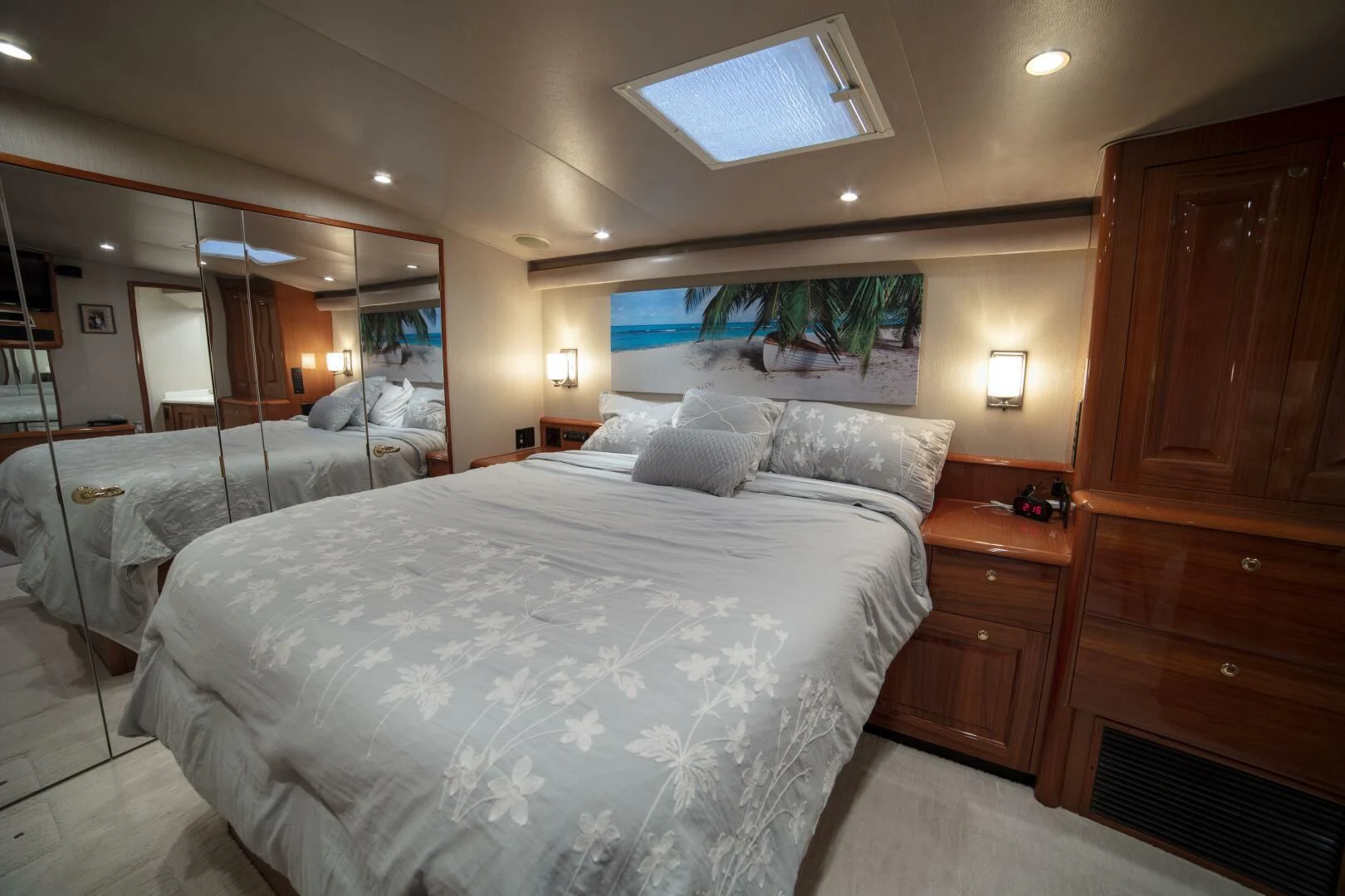 a room with a bed and a dresser aboard PRIME TIME Yacht for Sale