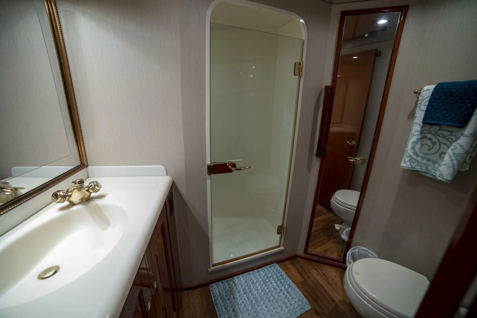 a bathroom with a glass shower door aboard PRIME TIME Yacht for Sale
