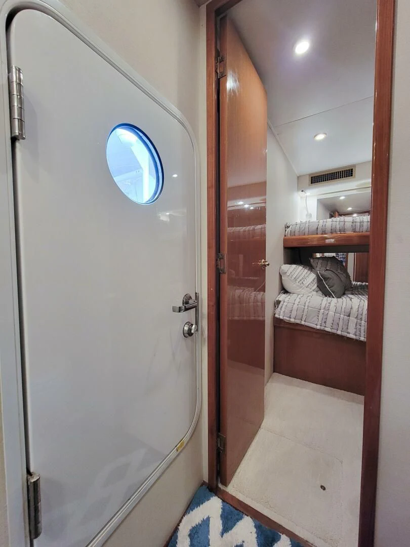a bathroom with a glass door aboard PRIME TIME Yacht for Sale