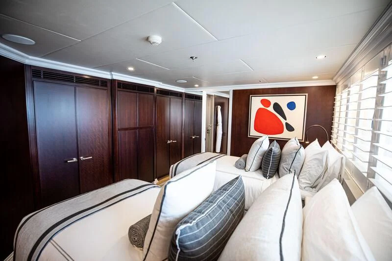 a room with a bed and cabinets aboard ALTA Yacht for Sale