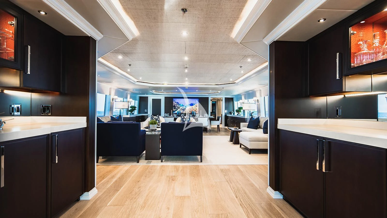 a modern looking kitchen with a wood floor aboard ALTA Yacht for Sale