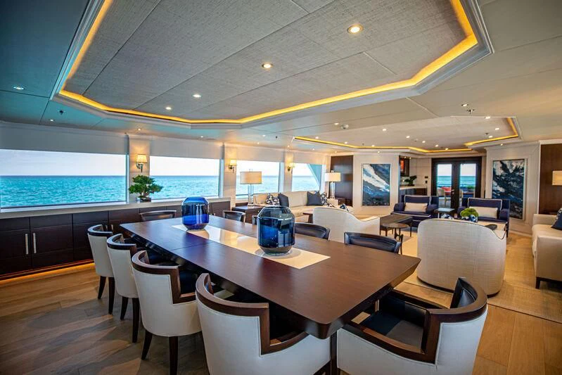 a room with tables and chairs aboard ALTA Yacht for Sale