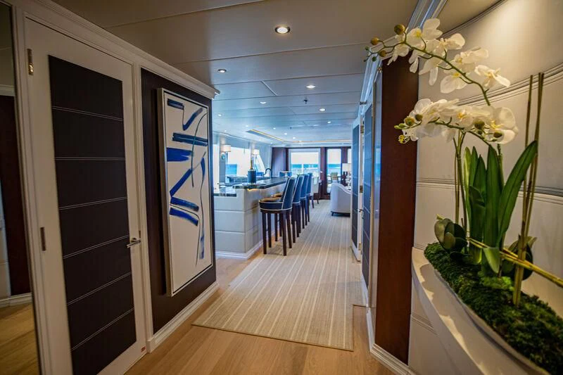 a room with a plant and a table and chairs aboard ALTA Yacht for Sale