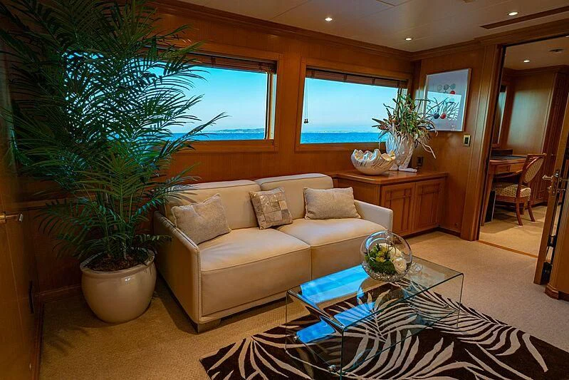 a living room with a couch and a plant aboard ALTA Yacht for Sale