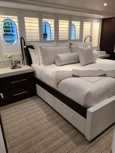 a bed with white sheets aboard ALTA Yacht for Sale