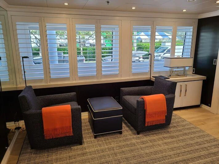 a room with a couch and a chair aboard ALTA Yacht for Sale