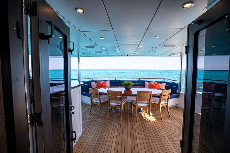 a room with a table and chairs aboard ALTA Yacht for Sale