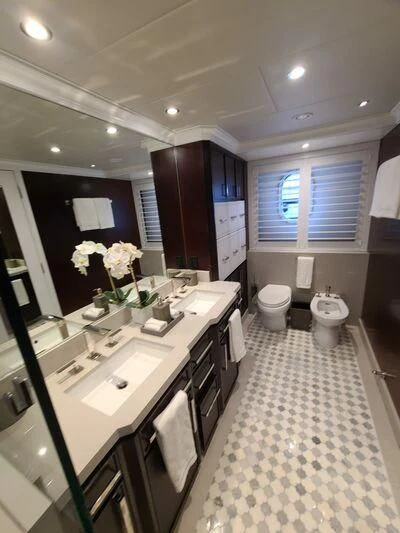 a kitchen with white cabinets aboard ALTA Yacht for Sale