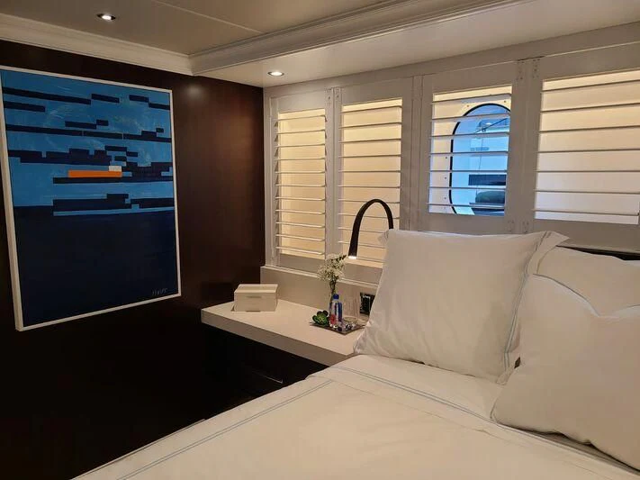 a bed with a white bed spread aboard ALTA Yacht for Sale