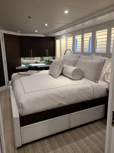 a bed with a white sheet aboard ALTA Yacht for Sale