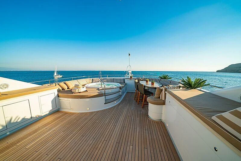 a deck with a view of the ocean and a beach aboard ALTA Yacht for Sale