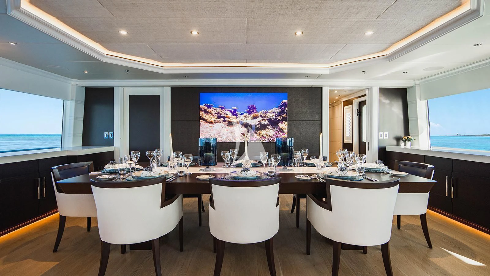a large room with tables and chairs aboard ALTA Yacht for Sale