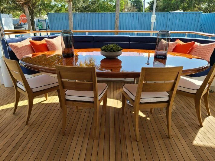 a table and chairs by a pool aboard ALTA Yacht for Sale