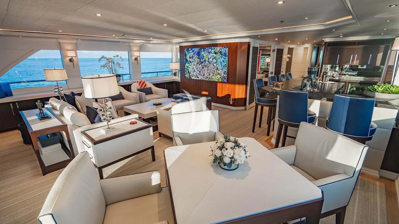 a room with a table chairs and a couch aboard ALTA Yacht for Sale