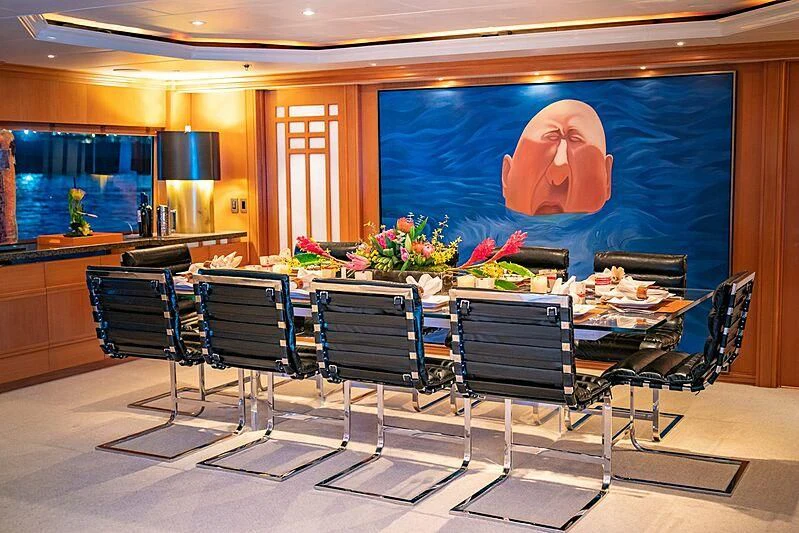 a large table with chairs and a painting on it aboard ALTA Yacht for Sale