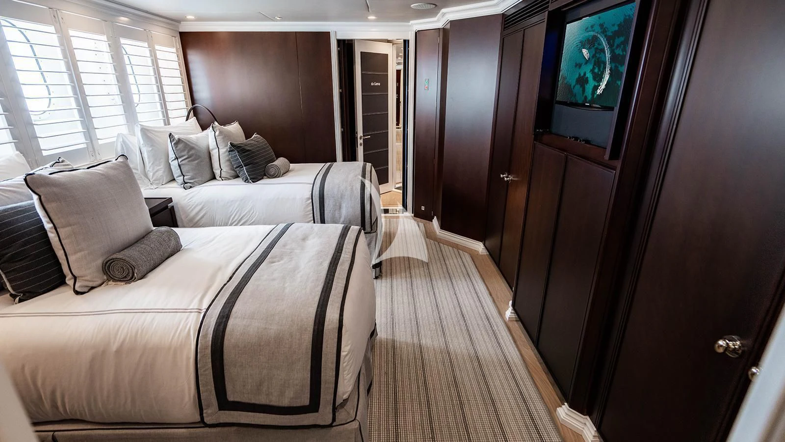 a room with a bed and a television aboard ALTA Yacht for Sale