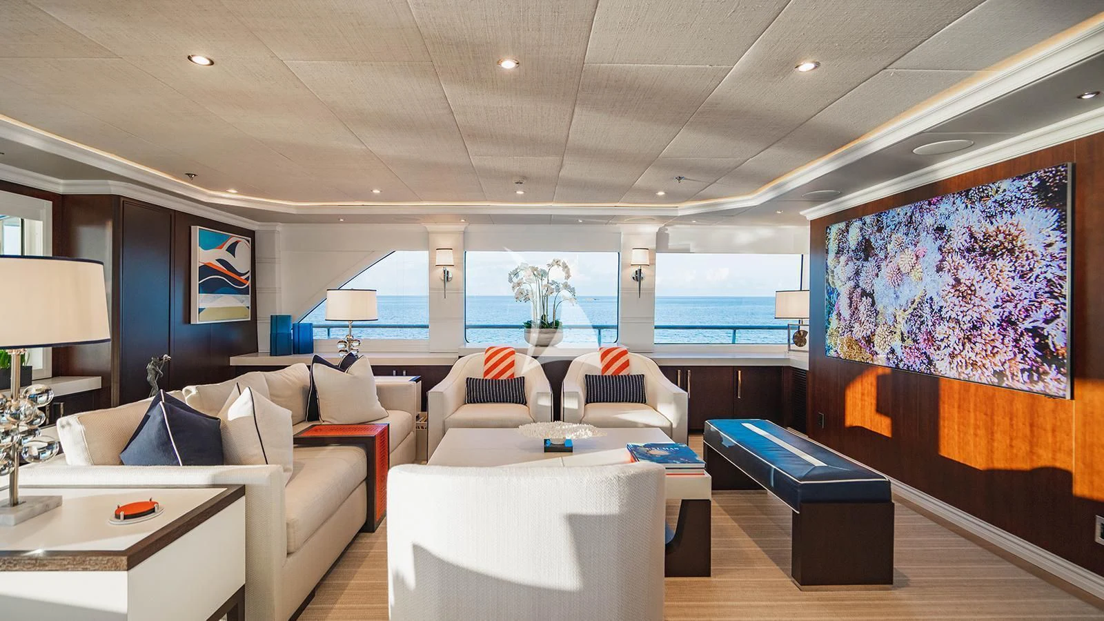 a room with a couch and a table and a large painting aboard ALTA Yacht for Sale