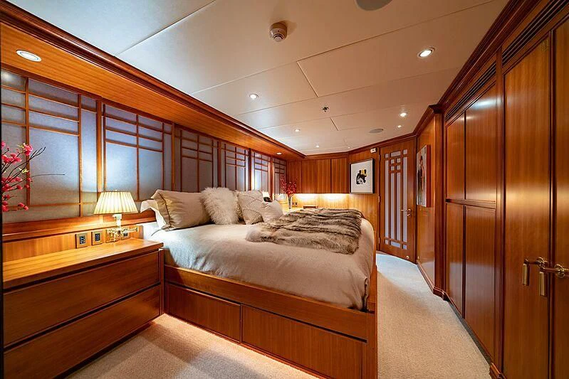 a room with a bed and a wood door aboard ALTA Yacht for Sale