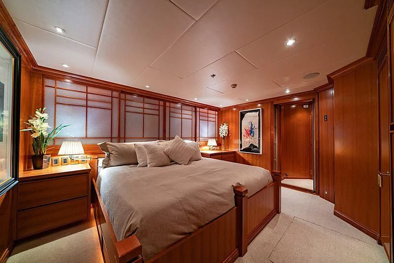 a bedroom with a bed and a desk aboard ALTA Yacht for Sale