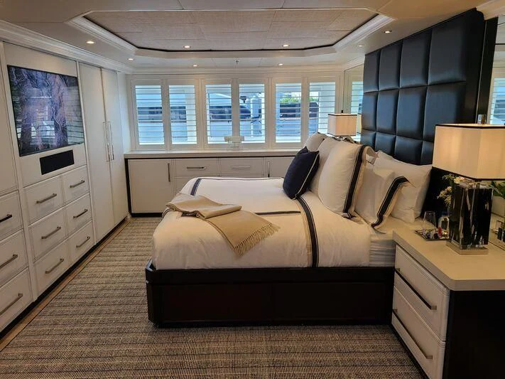 a bedroom with a bed and a desk aboard ALTA Yacht for Sale