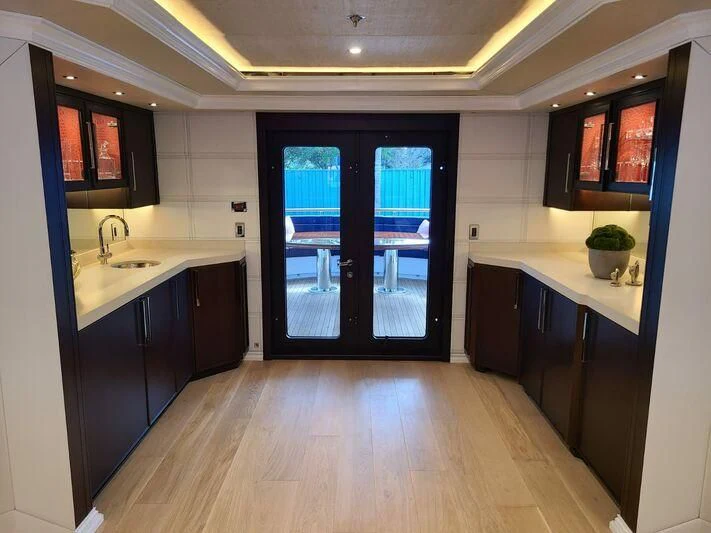 a kitchen with a blue door aboard ALTA Yacht for Sale