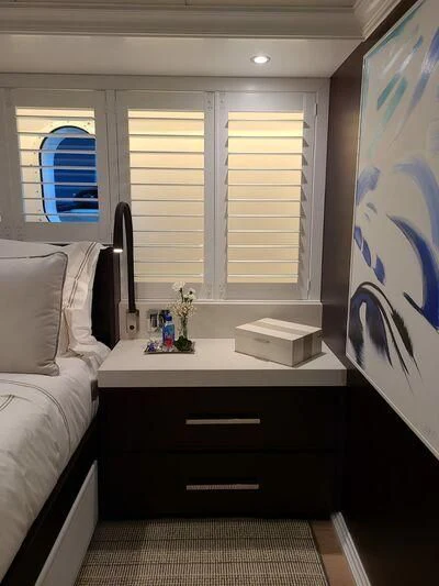 a bedroom with a desk and a bed aboard ALTA Yacht for Sale