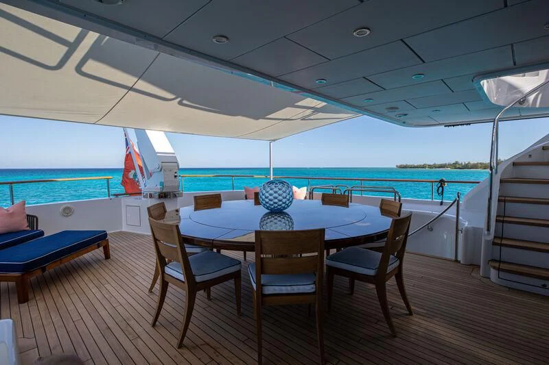 a table and chairs on a deck aboard ALTA Yacht for Sale