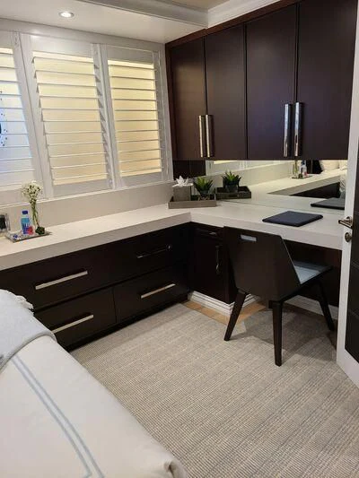 a kitchen with black cabinets aboard ALTA Yacht for Sale