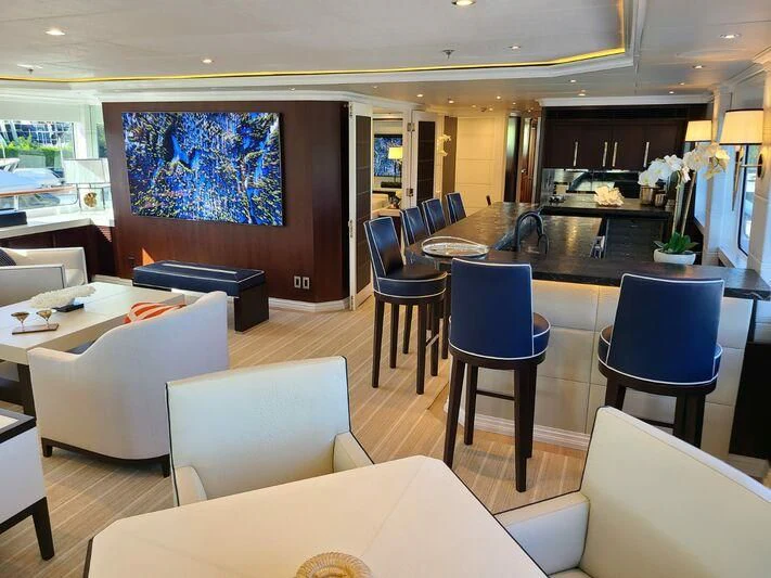 a room with tables and chairs aboard ALTA Yacht for Sale