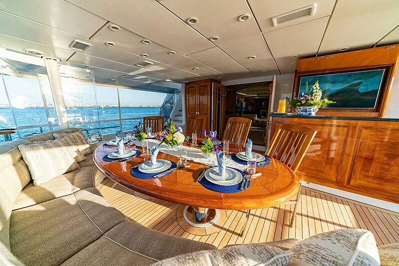 a living room with a large table and chairs aboard ALTA Yacht for Sale