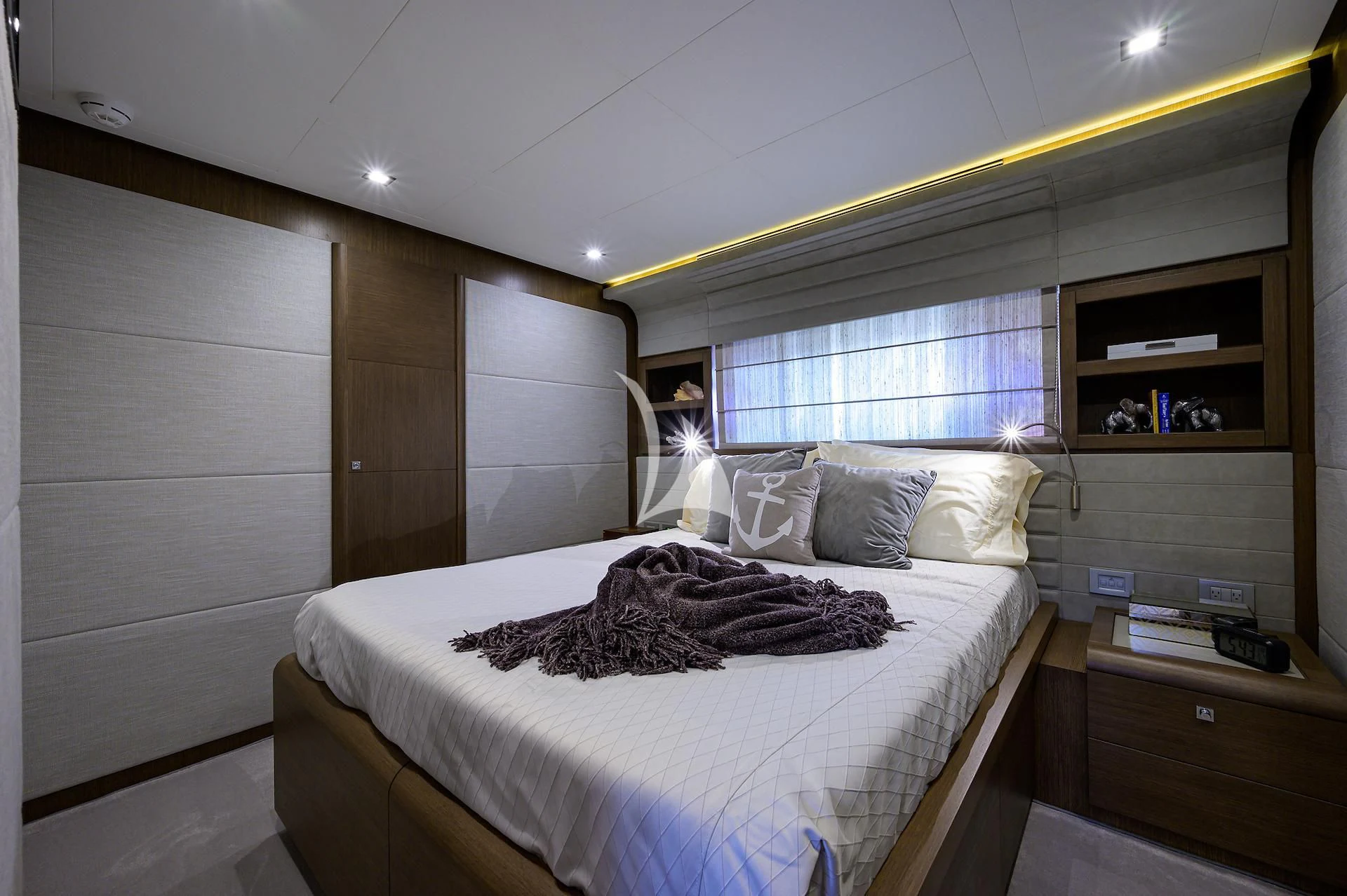 a bedroom with a bed and a desk aboard LEON Yacht for Sale