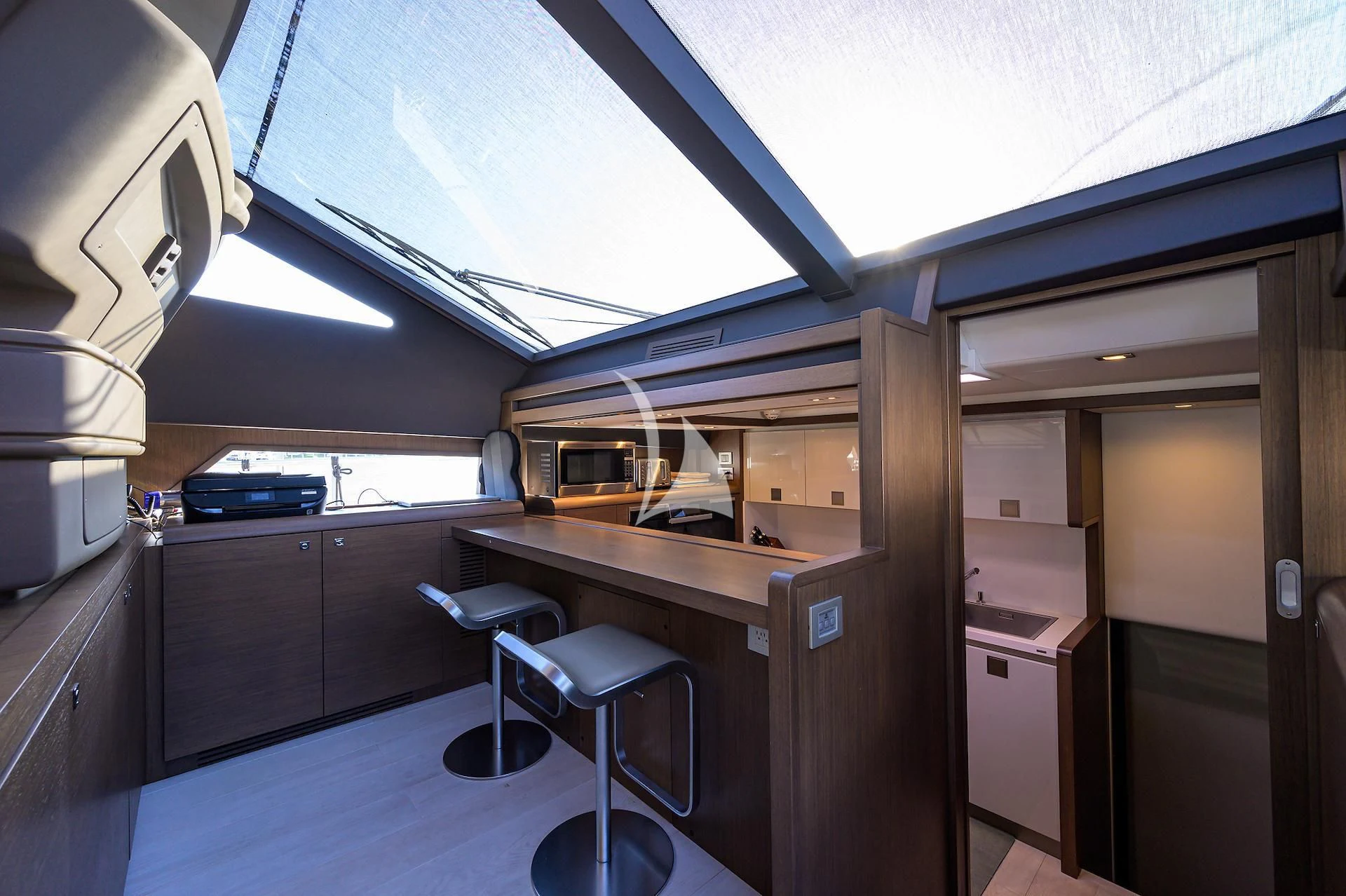 a room with a desk and chairs aboard LEON Yacht for Sale