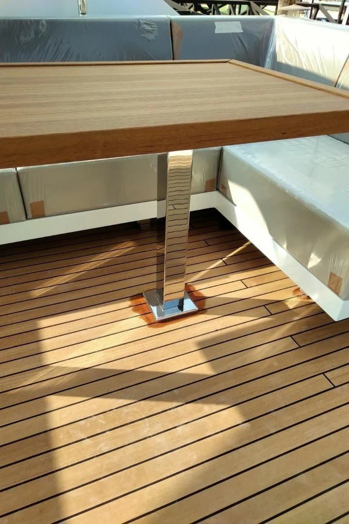 a wooden table with a glass top aboard SERENITY Yacht for Sale