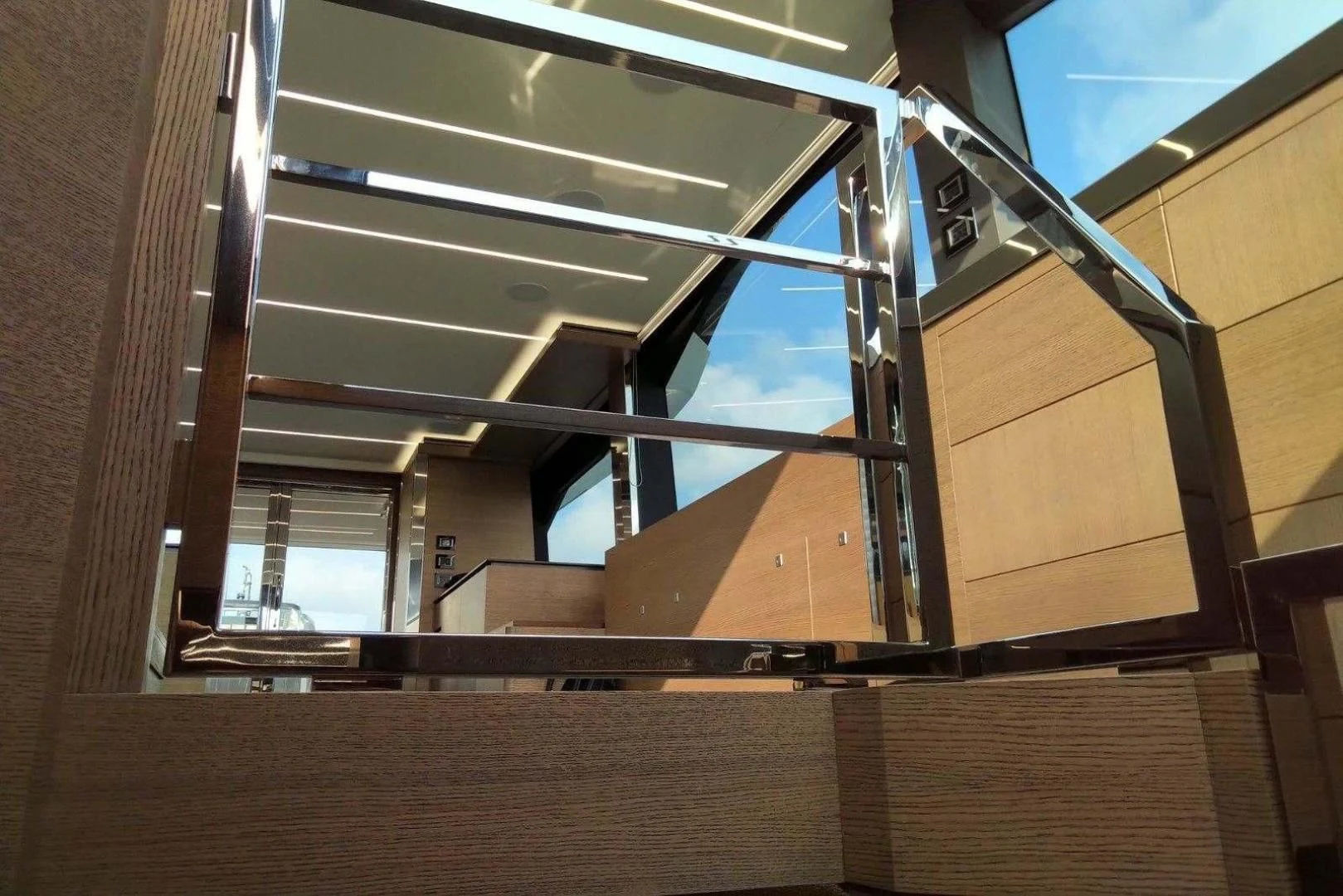 a wooden staircase with glass windows aboard SERENITY Yacht for Sale