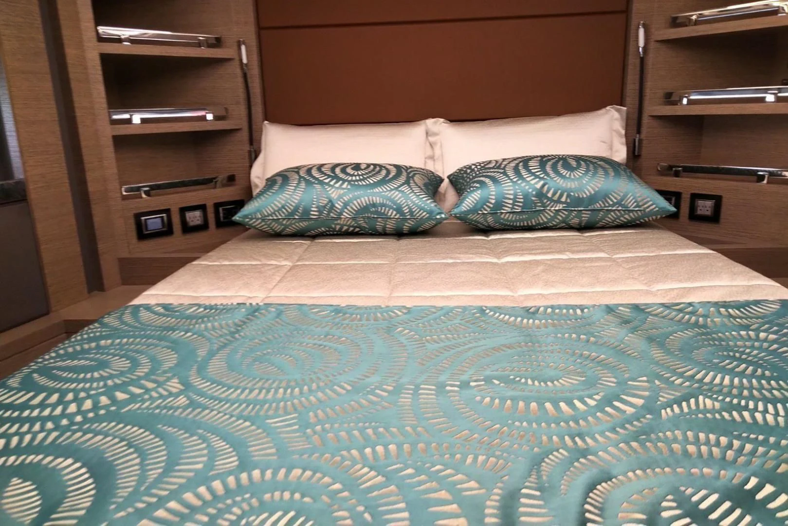 a bed with blue sheets aboard SERENITY Yacht for Sale