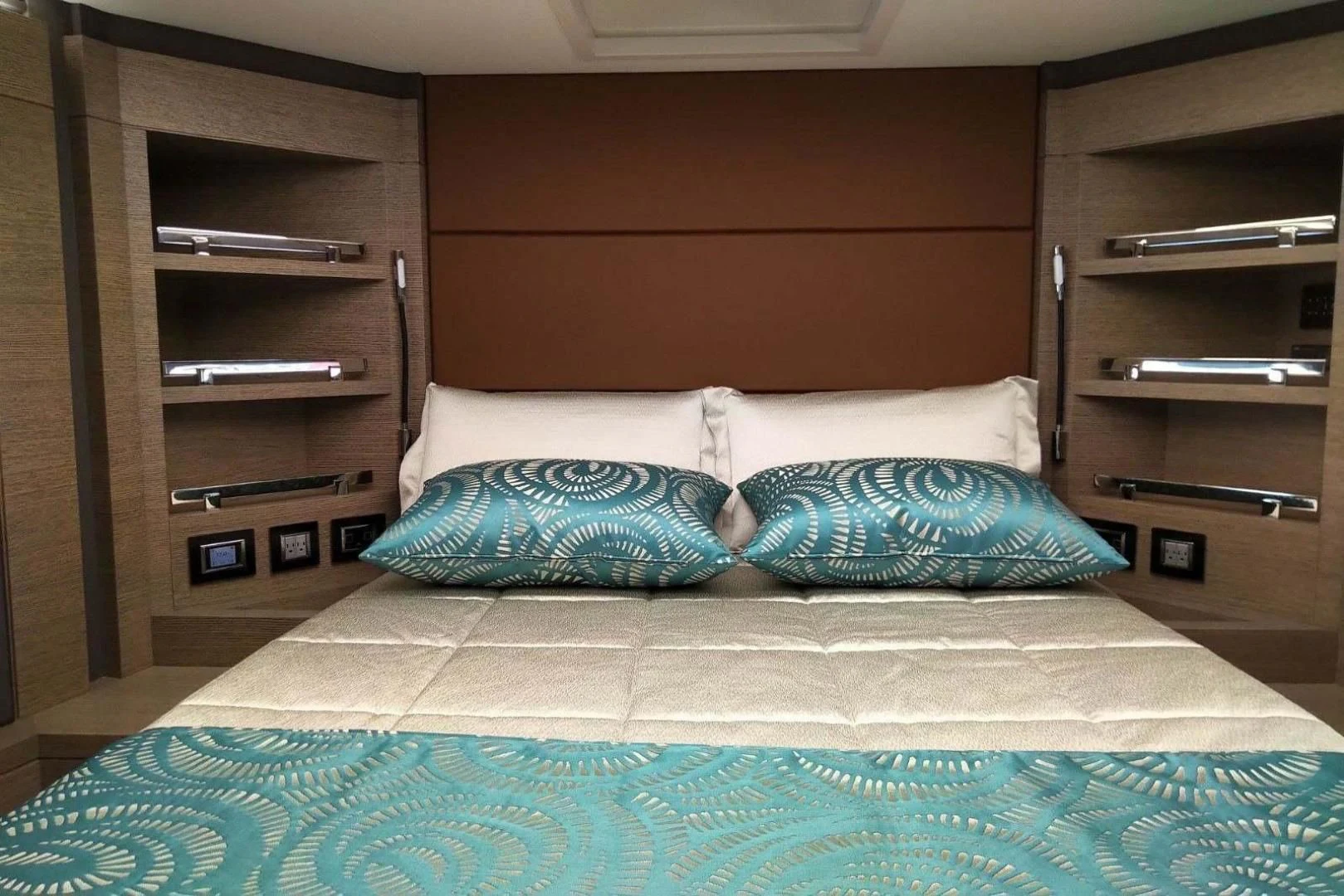 a bed with blue sheets aboard SERENITY Yacht for Sale