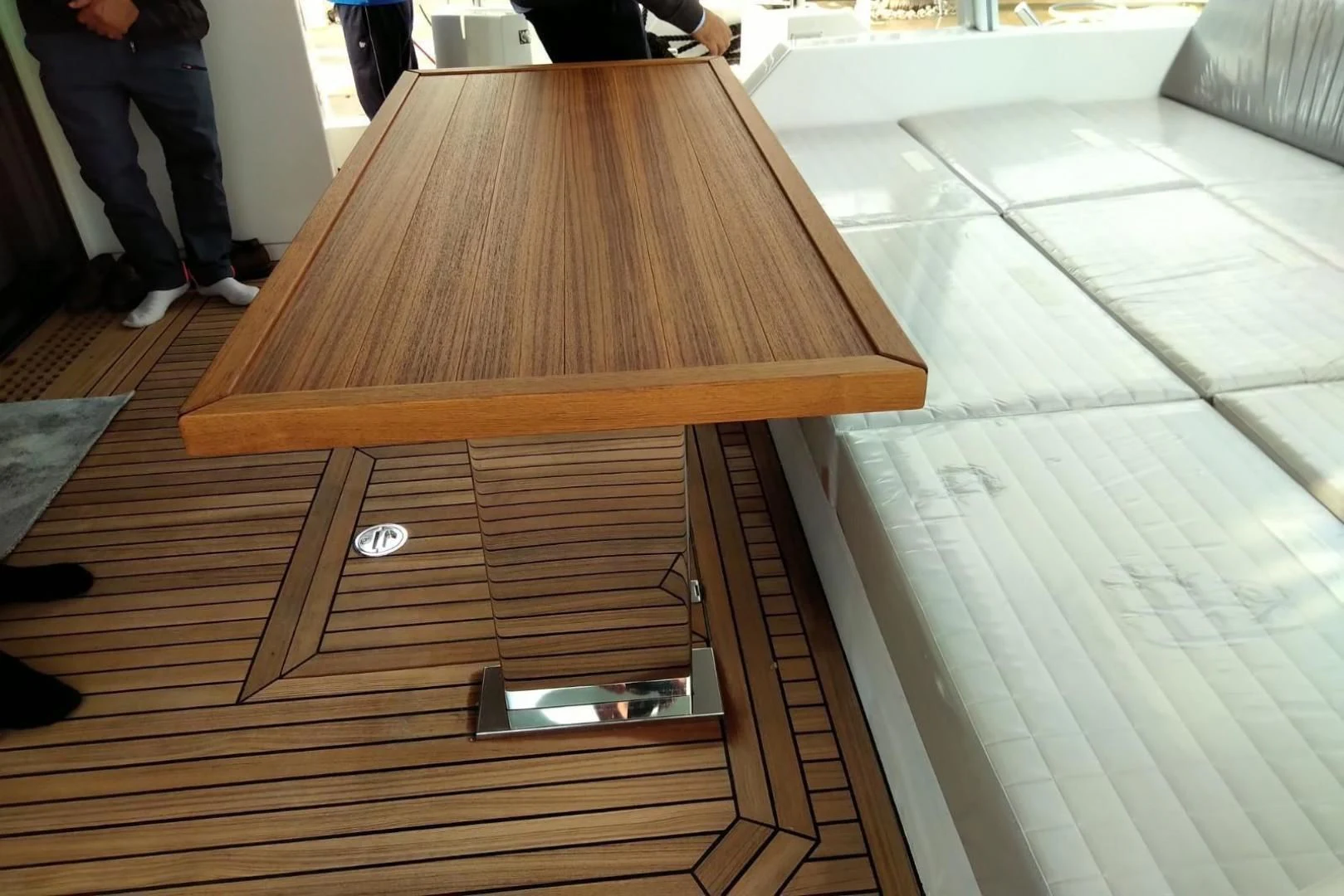 a wooden table on a tile floor aboard SERENITY Yacht for Sale