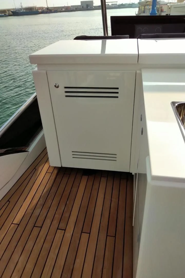 a white rectangular object on a wooden deck aboard SERENITY Yacht for Sale