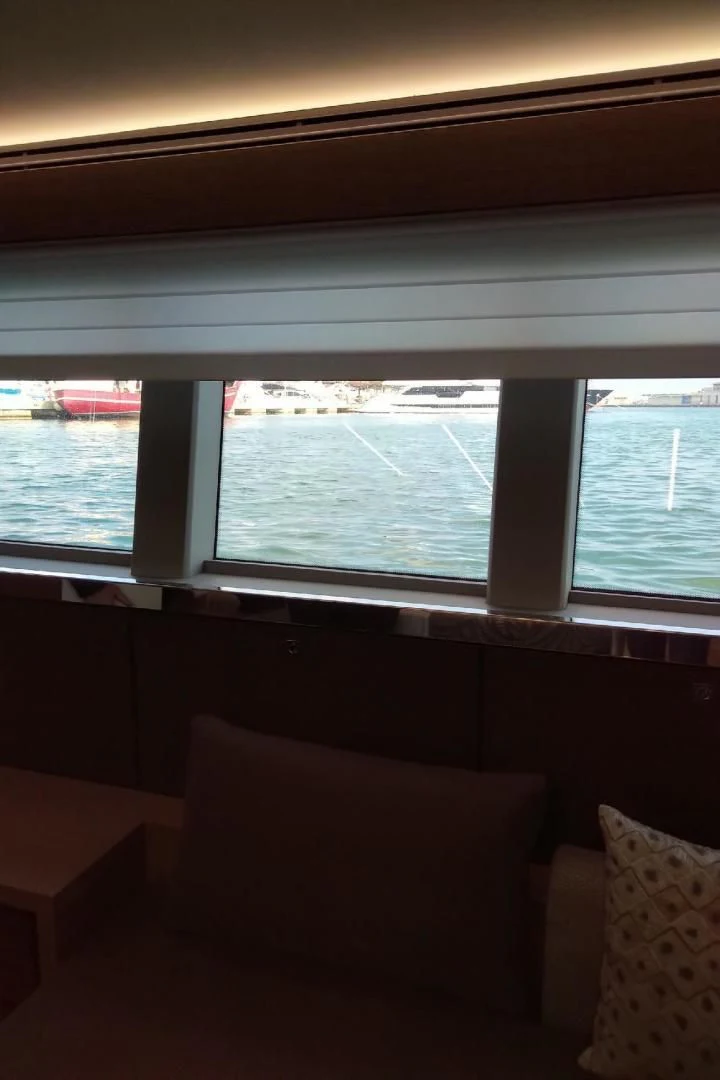 a room with a window and a couch aboard SERENITY Yacht for Sale